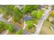 An elevated view of a well-maintained property, mature trees, and lush landscaping on a corner lot at 100 Nighthawk Ln, Summerville, SC 29485
