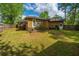 Large backyard featuring a lush lawn, mature trees, and a fenced perimeter at 100 Nighthawk Ln, Summerville, SC 29485