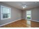 Bedroom features gleaming hardwood floors, modern ceiling fan, and dual windows at 100 Nighthawk Ln, Summerville, SC 29485