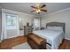 Cozy bedroom featuring a comfortable bed, a ceiling fan and beautiful wood floors at 100 Nighthawk Ln, Summerville, SC 29485