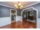 Charming dining area with hardwood floors, wainscoting, and stylish lighting fixtures at 100 Nighthawk Ln, Summerville, SC 29485