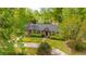 Scenic aerial view of a home surrounded by lush trees and a beautifully landscaped lawn at 100 Nighthawk Ln, Summerville, SC 29485