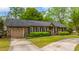 Charming brick home with a well-maintained lawn, paved driveway, and attached garage at 100 Nighthawk Ln, Summerville, SC 29485
