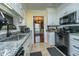 Well-lit kitchen features granite counters, white cabinets, and stainless steel appliances at 100 Nighthawk Ln, Summerville, SC 29485