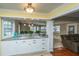 Eat-in kitchen bar with white cabinets, neutral granite countertop, and easy access to living room at 100 Nighthawk Ln, Summerville, SC 29485