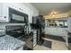 Kitchen featuring white cabinetry, granite countertops, black appliances, and tile floors at 100 Nighthawk Ln, Summerville, SC 29485