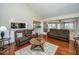 Inviting living area featuring hardwood floors, comfortable sofas, and open access to the kitchen at 100 Nighthawk Ln, Summerville, SC 29485