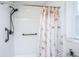Clean shower with white tile, grab bar, and updated shower head and curtain at 100 Nighthawk Ln, Summerville, SC 29485
