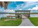 Scenic view of a waterfront wooden dock with picnic area and grilling station, perfect for outdoor activities and relaxing at 100 Tidewater Way, Charleston, SC 29492