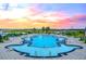 Gorgeous community pool at sunset with water views and comfortable lounge seating at 100 Tidewater Way, Charleston, SC 29492