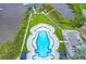 Aerial view of a luxury pool area with lounge chairs, cabanas, and a beautiful landscape design near the water at 100 Tidewater Way, Charleston, SC 29492