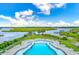Stunning community pool with lounge chairs overlooking the serene marsh and waterway at 100 Tidewater Way, Charleston, SC 29492