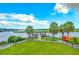 Scenic view overlooking waterfront with palm trees, kayaks, and a charming pier at 100 Tidewater Way, Charleston, SC 29492