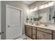 Bathroom featuring double vanity, granite countertop, large mirror, and modern fixtures at 1000 Winding Grove Ln, Moncks Corner, SC 29461