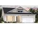 Single-story home with beige siding, a covered entryway, and an attached two-car garage at 1000 Winding Grove Ln, Moncks Corner, SC 29461