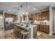 Open-concept kitchen with dark wood cabinets, a center island with bar seating, and stainless steel appliances at 1000 Winding Grove Ln, Moncks Corner, SC 29461