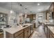 Spacious kitchen features wooden cabinets, granite counters, a large island, and pendant lighting at 1000 Winding Grove Ln, Moncks Corner, SC 29461