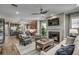 Cozy living room featuring a fireplace, plush seating, and an open view of the modern kitchen at 1000 Winding Grove Ln, Moncks Corner, SC 29461