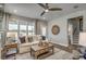 Bright and airy living room boasts neutral decor, a comfortable sofa, and scenic backyard views at 1000 Winding Grove Ln, Moncks Corner, SC 29461