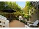 Private backyard featuring a deck, lush greenery, and comfortable seating area at 1012 Ashley Ave, Charleston, SC 29403