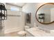 Bright bathroom featuring a marble vanity, round mirror, and subway tile shower at 1012 Ashley Ave, Charleston, SC 29403