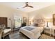 Cozy bedroom with warm neutral tones, ceiling fan, and decorative rattan headboard at 1012 Ashley Ave, Charleston, SC 29403