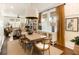 Spacious dining area featuring a wooden table, windows with shades, and connection to the adjacent living room at 1012 Ashley Ave, Charleston, SC 29403