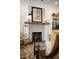 Close-up on a fireplace with a gray brick surround and wooden mantel, accentuated by decorative items at 1012 Ashley Ave, Charleston, SC 29403