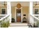 Inviting front porch featuring a wood door, stylish light fixture, and ample space at 1012 Ashley Ave, Charleston, SC 29403