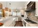 Modern kitchen features white cabinets, stainless appliances, and stone accents at 1012 Ashley Ave, Charleston, SC 29403