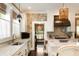 Bright, stylish kitchen with white cabinetry, stone accent wall, and stainless-steel appliances at 1012 Ashley Ave, Charleston, SC 29403