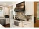 Kitchen with stone accents, white cabinetry, a gas range, and marble countertops for a luxurious feel at 1012 Ashley Ave, Charleston, SC 29403