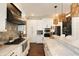 Well-appointed kitchen featuring white cabinets, stone accent wall, stainless-steel appliances, and pendant lighting at 1012 Ashley Ave, Charleston, SC 29403