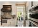 Bright kitchen with stainless oven and range and access to screened-in porch at 1012 Ashley Ave, Charleston, SC 29403