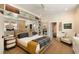 Spacious bedroom with a bed, large mirror, built-in shelves, and a doorway to the bathroom at 1012 Ashley Ave, Charleston, SC 29403