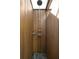 Outdoor shower with wood paneling, stone floor, shower head, and mounted accessories at 1012 Ashley Ave, Charleston, SC 29403