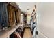 Organized walk-in closet with shelves and hanging rods filled with shoes, clothes, and accessories at 1012 Ashley Ave, Charleston, SC 29403
