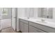 Bright bathroom featuring double vanity with white countertops, gray cabinets, and an open doorway to the bedroom at 1064 Forrest Creek Dr, Summerville, SC 29483