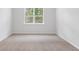 An empty bedroom with neutral walls and carpeting, offering a serene and blank canvas for personalization at 1064 Forrest Creek Dr, Summerville, SC 29483