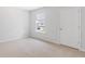 This bedroom offers a neutral carpet, bright window, and a door to the hall at 1064 Forrest Creek Dr, Summerville, SC 29483
