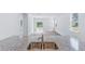 A kitchen featuring granite countertops, a stainless steel sink, and white walls overlooks a living space with sliding glass doors at 1064 Forrest Creek Dr, Summerville, SC 29483