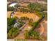 An aerial view showcases the estate's spacious layout, including the home, pasture, and surrounding woodland at 1068 Witherbee Rd, Moncks Corner, SC 29461