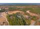Expansive aerial shot showcasing a secluded estate nestled among dense trees and winding roads, offering privacy and tranquility at 1068 Witherbee Rd, Moncks Corner, SC 29461
