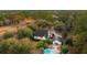 Stunning aerial view of a home with a pool, nestled among trees and surrounded by lush landscapes at 1068 Witherbee Rd, Moncks Corner, SC 29461