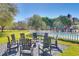 Backyard patio with chairs around a fire pit and a partial pool view at 1068 Witherbee Rd, Moncks Corner, SC 29461