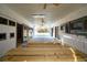 Well-lit barn interior with multiple stalls and a clear view of the outdoor landscape at 1068 Witherbee Rd, Moncks Corner, SC 29461