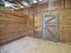 Rustic barn stall featuring wooden walls, a sturdy door, and a functional washbasin at 1068 Witherbee Rd, Moncks Corner, SC 29461