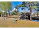 A charming wooden bridge traverses a serene stream, enhanced by decorative vintage lighting and natural scenery at 1068 Witherbee Rd, Moncks Corner, SC 29461