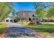 Beautiful white home with fountain, attached garage, and meticulously maintained landscaping at 1068 Witherbee Rd, Moncks Corner, SC 29461