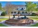 A striking fountain adorns the front lawn of this charming home, complete with manicured landscaping at 1068 Witherbee Rd, Moncks Corner, SC 29461